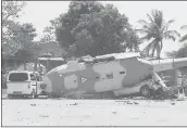  ?? LUIS ALBERTO CRUZ HERNANDEZ — THE ASSOCIATED PRESS ?? A downed helicopter lays on its side in Santiago Jamiltepec, Oaxaca state, Mexico, on Saturday.