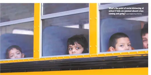  ?? SUN-TIMES FILE PHOTO ?? What’s the point of social distancing at school if kids are jammed aboard a bus coming and going?