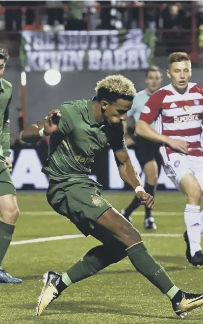  ??  ?? Celtic’s Scott Sinclair scores his second goal of the night against Hamilton from a narrow angle to make it 3-0 to Brendan Rodgers’ side, who extended their run to 54 domestic games unbeaten.