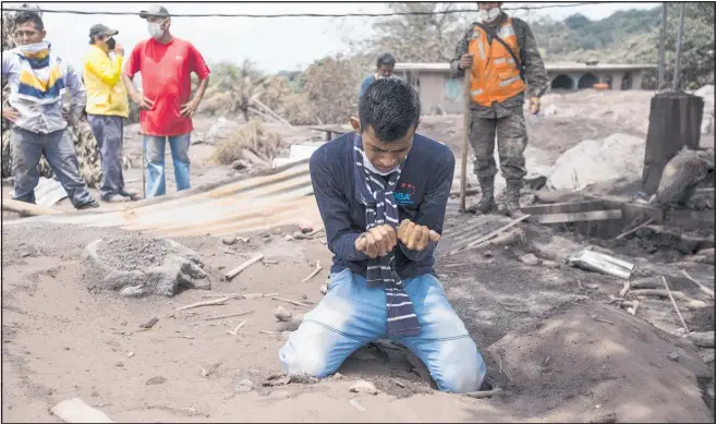  ?? PHOTO / AP ?? Bryan Rivera cries after looking at the remains of his house, after his family went missing during the Volcan de Fuego eruption.