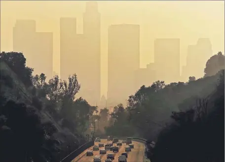  ?? Luis Sinco Los Angeles Times ?? THE EPA found some of the nation’s most affected areas in places such as South Los Angeles, Maywood and Santa Ana, where low-income and minority population­s face increased risk of exposure to lead paint. Above, a thick haze hangs over L.A. in January.