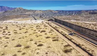  ??  ?? The new border wall meets the old wall on Wednesday near Santa Teresa.