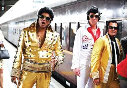  ?? PETER PARKS/AFP ?? Elvis fans arrive at Central station before boarding a train to The Parkes Elvis Festival, in Sydney on Thursday.