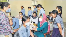  ?? ?? A health worker administer­s a Covid vaccine to a student at a government school in Jalandhar.