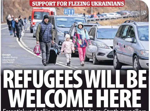  ?? ?? Families fleeing Ukraine walk into Poland