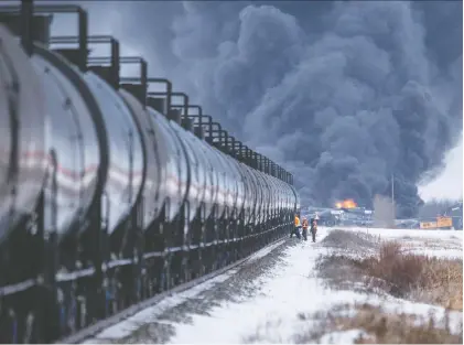  ?? LIAM RICHARDS ?? Emergency crew respond to a Canadian Pacific Railway train derailment near Guernsey, Thursday. No injuries or fatalities were reported.