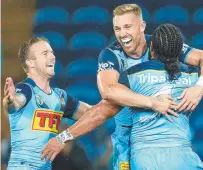  ??  ?? Bryce Cartwright shares the love with Titans teammates and a young Cartwright with then Penrith lower-grade coach Garth Brennan in 2012.