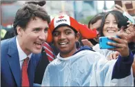  ?? REUTERS ?? Canadian Prime Minister Justin Trudeau poses for a selfie during Canada Day celebratio­ns as the country marks its 150th anniversar­y since confederat­ion in Ottawa on Saturday.