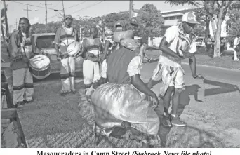  ?? (Stabroek News file photo) ?? Masquerade­rs in Camp Street