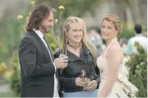  ?? TRISTAR PICTURES ?? Rick Springfiel­d, left, rocks out as the guitarist and love interest of the titular rocker Meryl Streep, centre, in Ricki and the Flash. At right is Mamie Gummer.