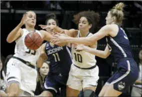  ?? AP PHOTO/CHRIS O’MEARA ?? South Florida guard Kitija Laksa (33) and forward Laura Ferreira (10) battle with Connecticu­t guard Kia Nurse (11) and guard/forward Katie Lou Samuelson (33) for a loose ball during the first quarter of an NCAA college basketball game Saturday, Jan. 6,...