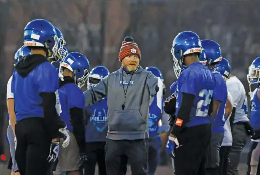  ?? KIRSTEN STICKNEY/SUN-TIMES ?? Coach Troy McAllister and Phillips started practice Wednesday without defensive coordinato­r Mike Larson, who died unexpected­ly in January.