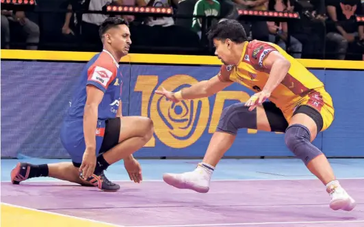  ?? ?? Making inroads: Rahul Sethpal (in blue) in action against Telugu Titans' Pawan Sehrawat. PKL