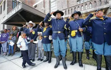  ?? Melissa Phillip / Houston Chronicle ?? Buffalo Soldiers salute during Saturday’s ceremonies recognizin­g the opening of the third-floor expansion of the Buffalo Soldiers National Museum on Veterans Day.