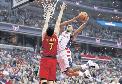  ?? AFP ?? The Wizards’ Bradley Beal puts up a shot in front of the Hawks’ Ersan Ilyasova.