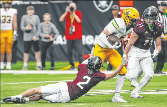  ?? Madeline Carter Las Vegas Review-journal ?? Faith Lutheran’s Brandon Soares (2) stretches to make a tackle during the Crusaders’ 40-21 loss to Bishop Manogue.