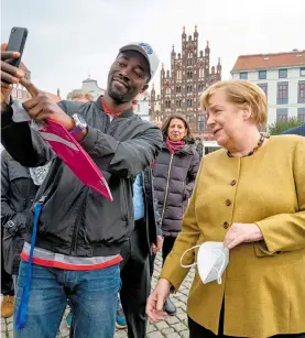 ?? AFP ?? La canciller alemana visitó su antiguo distrito electoral en Greifswald durante la campaña de su partido