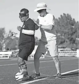  ?? OLIVIA GYAPONG/THE REPUBLIC ?? Blind soccer player Alvaro Mora Arellano practices with friend and trainer Don Marshall at Arizona Christian University in Glendale.