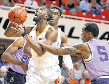  ?? [PHOTO BY BRYAN TERRY, THE OKLAHOMAN] ?? Oklahoma State’s Tavarius Shine goes past Kansas State’s Barry Brown during Wednesday’s game at Gallagher-Iba Arena in Stillwater.