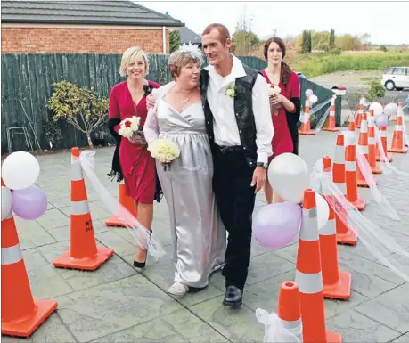  ?? Photo: DEAN KOZANIC ?? Special pathway: Newlyweds Gillian and Doug Mackinnon with their bridesmaid­s Jacqueline Harrison, left, and Trudi Robertson head for their reception.