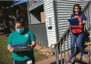  ??  ?? Communitie­s In Schools student support manager Nguyet “Mimi” Tran, left, and Bush Elementary School family liaison Johana Santacruz visit families at an apartment complex in Alief last October.