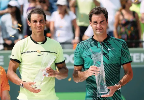  ?? PICTURE: AP ?? LAST MEETING: Rafael Nadal, of Spain, left, and Roger Federer, of Switzerlan­d, with their trophies after the final at the Miami Open in April. Federer triumphed 6-3 6-4.