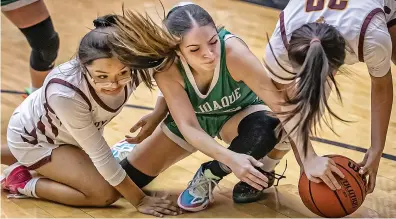  ?? JIM WEBER/NEW MEXICAN FILE PHOTO ?? Pojoaque’s Kaylee Martinez, center, battles for a loose ball with Santa Fe Indian School guard Daneen Herrera, left, and forward Kaydence Riley during a game earlier this season. The Lady Braves are the No. 4 seed in Class 3A and will play a home game.