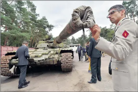  ?? Picture: SERGEI SUPINSKY/GETTY ?? A military attache in Kiev examines a Russian tank yesterday after it was seized from separatist­s by Ukrainian forces