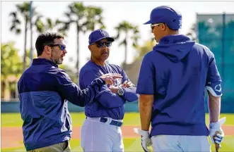  ?? KENT NISHIMURA / LOS ANGELES TIMES ?? Los Angeles Dodgers president of baseball operations Andrew Friedman (from left), manager Dave Roberts and outfielder Joc Pederson talk during practice in February. Owners are nearing a proposal to play that would let the Dodgers chase their first World Series title in 32 years.