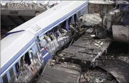  ?? GIANNIS PAPANIKOS — THE ASSOCIATED PRESS ?? Debris of trains lie on the rail lines after a collision in Tempe, Greece, on Wednesday.