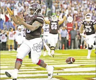  ?? Photo by Getty ?? Mississipp­i State’s Josh Robinson celebrates one of his two touchdowns as No. 3 Bulldogs score third straight win over Top 10 SEC West opponent.