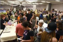  ?? PHOTO PROVIDED ?? Attendees check out vegan options at the 2018 Albany VegFest.