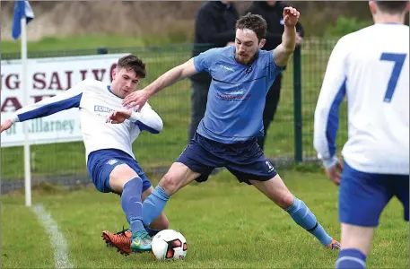  ??  ?? William Courtney, Killarney Athletic keeps the ball in play marked by Donnacha Higgins, Dingle in the League clash at Woodlawn, Killarney on Sunday Photo by Michelle Cooper Galvin