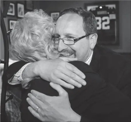  ?? Grant Black, Calgary Herald ?? Wildrose candidate Grant Galpin embraces a supporter at his celebratio­n party in the riding of Calgary-mccall, in Monday’s provincial election.