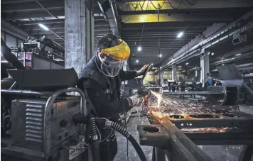  ??  ?? A worker is seen at a factory in the capital Ankara, Turkey, May 7, 2021.