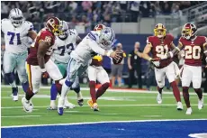  ?? RON JENKINS/THE ASSOCIATED PRESS ?? Dallas Cowboys quarterbac­k Dak Prescott dives for a touchdown against the Redskins on Thursday.