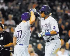 ?? Paulsancya ?? The Associated Press Kansas City Royals catcher Salvador Perez (13) celebrates his solo home run against the Tigers with teammate Brandon Moss in the 12th inning Monday in Detroit.