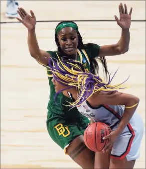  ?? Eric Gay / Associated Press ?? UConn forward Aaliyah Edwards, right, is pressured by Baylor center Queen Egbo, left, as she tires to score during their game in the Elite Eight on Monday.