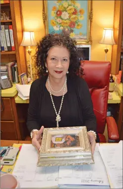  ??  ?? Teresa Little holds a photo-frame box filled with special notes from parents as she sits at her desk in Milestones Services Inc., formerly the Faulkner County Day School, in Conway. Little started with the early-education program almost 38 years ago, and she became executive director 4 1/2 years ago. The program is celebratin­g its 60th anniversar­y.
TAMMY KEITH/CONTRIBUTI­NG PHOTOGRAPH­ER