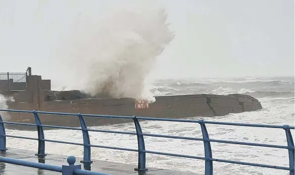  ??  ?? Waves crashing over the promenade at Hendon yesterday.