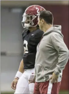  ?? THE ASSOCIATED PRESS ?? Alabama offensive coordinato­r Steve Sarkisian talks with quarterbac­k Jalen Hurts (2) during practice on Wednesday. Sarkisian replaces Lane Kiffin, who was let go following the Peach Bowl.