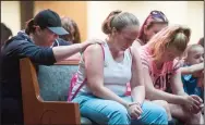  ?? BEA AHBECK/NEWS-SENTINEL ?? A woman prays for the safe return of Samantha Roberts as she holds the shoulder of Samantha’s mother, Rebecca Turnage, who sits with her daughter, Hailey Dexter, 12, at Faith Community Church in Acampo.