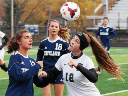  ?? RANDY MEYERS — THE MORNING JOURNAL ?? Ryan Kunkle of Elyria Catholic heads the ball in front of Kirtland’s Jessica Hepper during the first half.