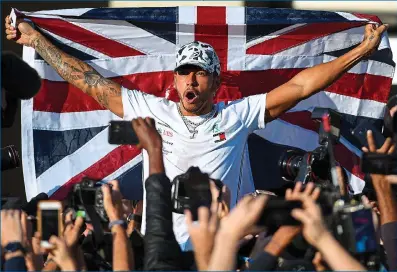  ??  ?? Great Briton: Hamilton celebrates winning his sixth world title at the US Grand Prix on Sunday