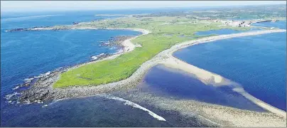  ?? SUBMITTED PHOTO ?? This aerial view shows Rochefort Point, in the foreground, with the reconstruc­ted quarter of the Fortress of Louisbourg visible in the back right. The point is the site of a historic graveyard that is in jeopardy due to coastal erosion. Parks Canada is...