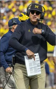  ?? ASSOCIATED PRESS FILE PHOTO ?? Michigan head coach Jim Harbaugh will likely lead the Wolverines on to the field with an empty stadium when the 2020season begins if students have not return to campus.