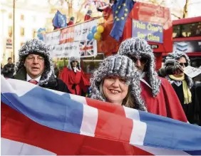  ??  ?? > Pro-Europe protestors dressed as Supreme Court Justices stand outside the Supreme Court yesterday