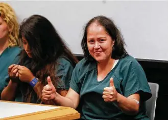  ?? John Bazemore / Associated Press ?? Isabel Martinez gestures toward news cameras Friday during her first court appearance in Lawrencevi­lle, Ga. Immigratio­n officials say the Mexican native entered the U.S. illegally.