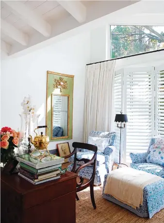  ??  ?? clockwise, from le f t Julia twigg had two of the armchairs in the main bedroom recovered in blue-and-white tablecloth­s. the desk was a wedding gift from a friend; the homeowner made the decision not to cover the overhead windows in the bedroom,...