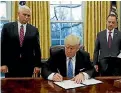  ??  ?? President Trump formally destroying the TPP.